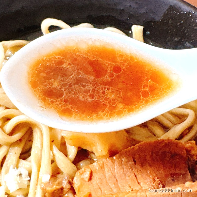 ラーメンゼンゼンの微乳化スープをレンゲですくったところ